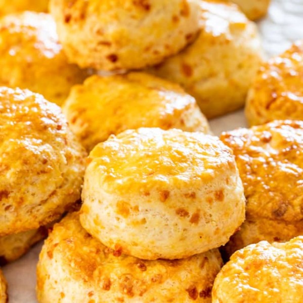 side view shot of cheddar buttermilk biscuits stacked in a pile
