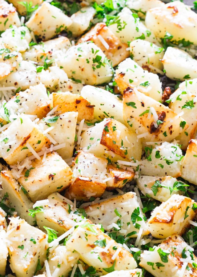 Parmesan Garlic Roasted Potatoes on a baking sheet garnished with parsley