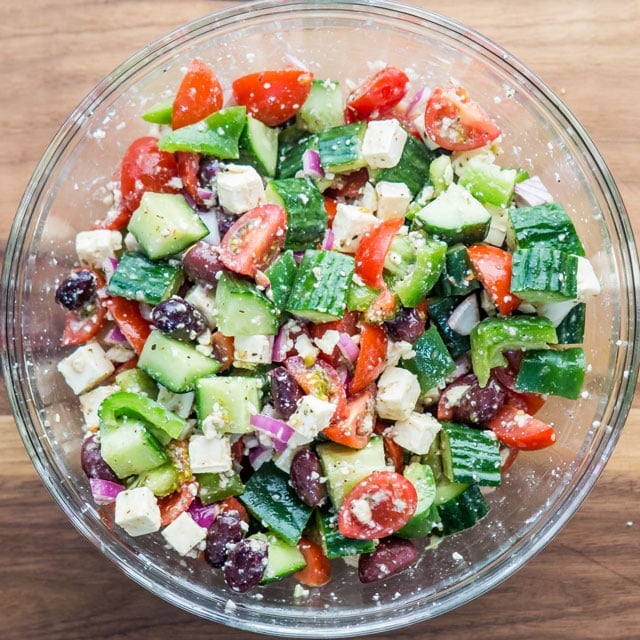 Large mixing bowl filled with greek salad