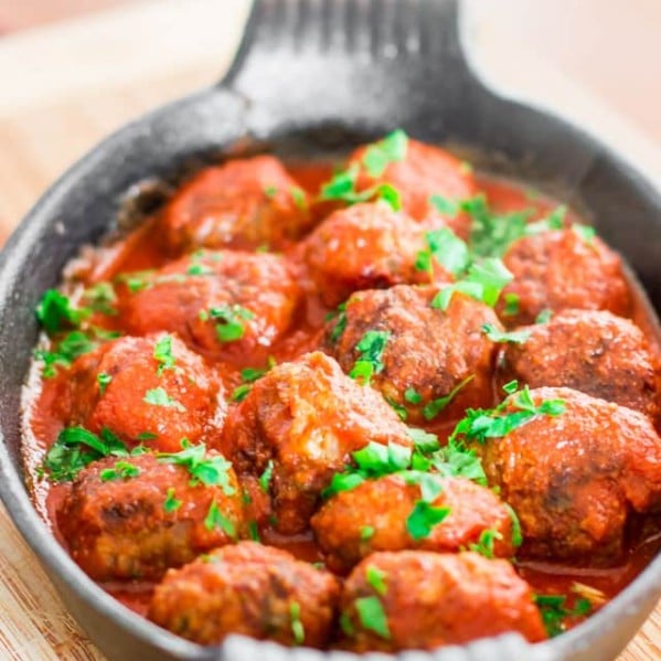 a dish full of spicy ricotta meatballs in tomato sauce