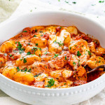 side view shot of cheesy gnocchi bake in a bowl