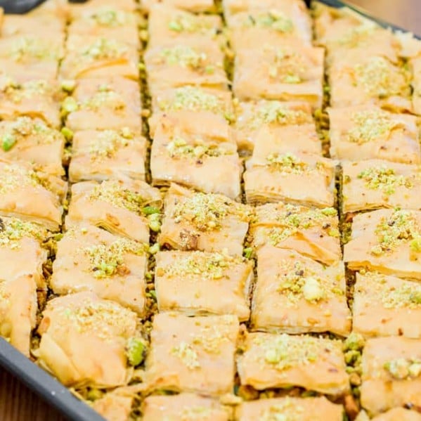 side view shot of pistachio baklava on a baking sheet