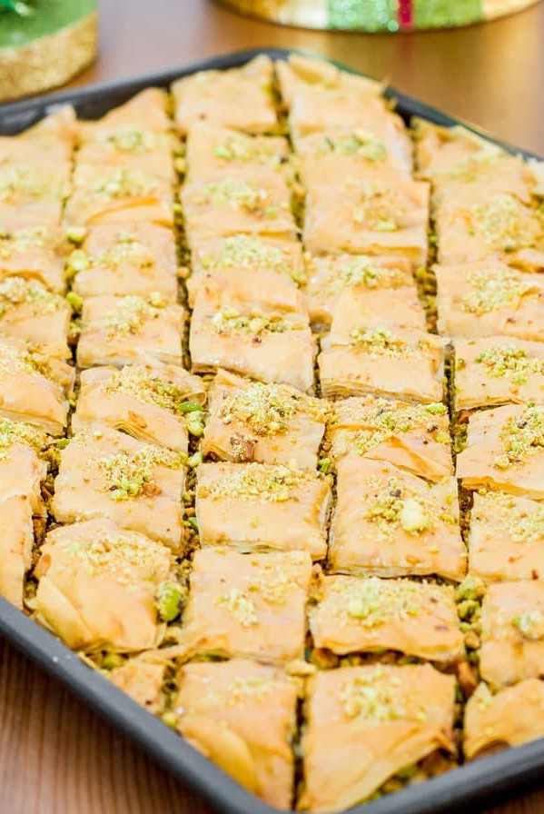 side view shot of pistachio baklava on a baking sheet
