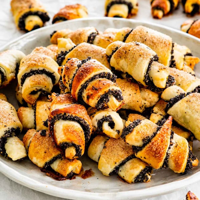 a bunch of poppy seed rugelach cookies on a plate.