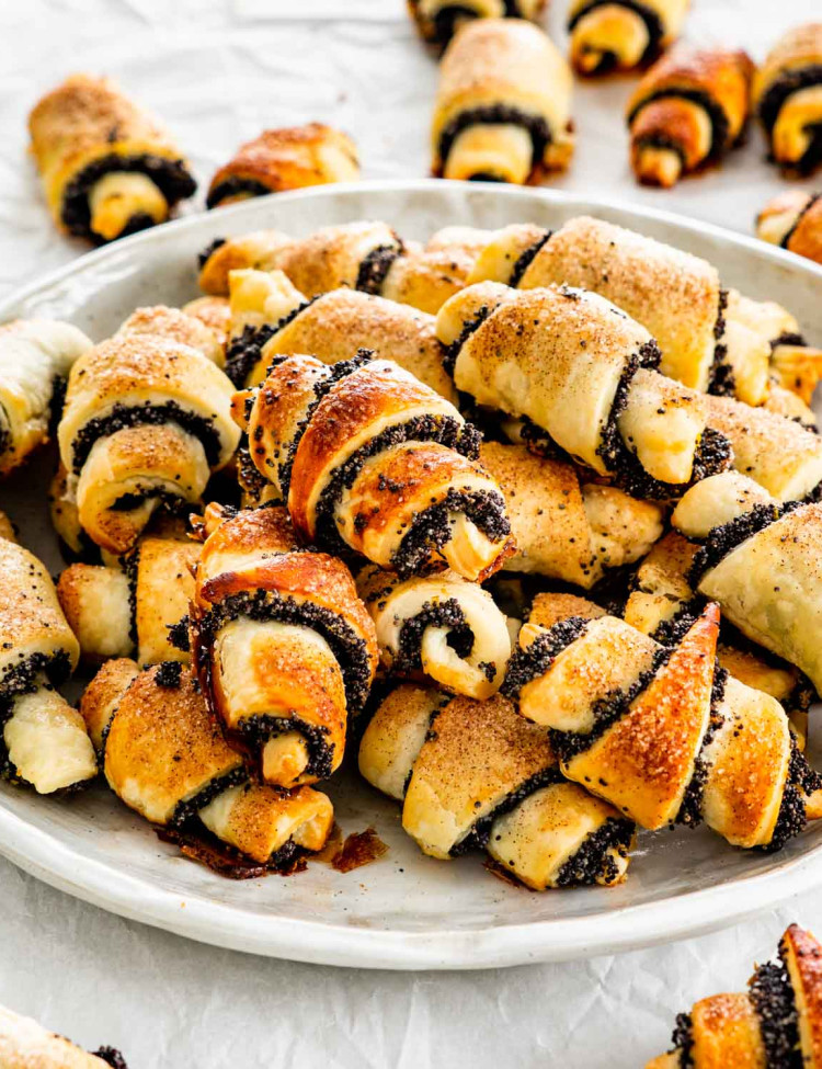 a bunch of poppy seed rugelach cookies on a plate.