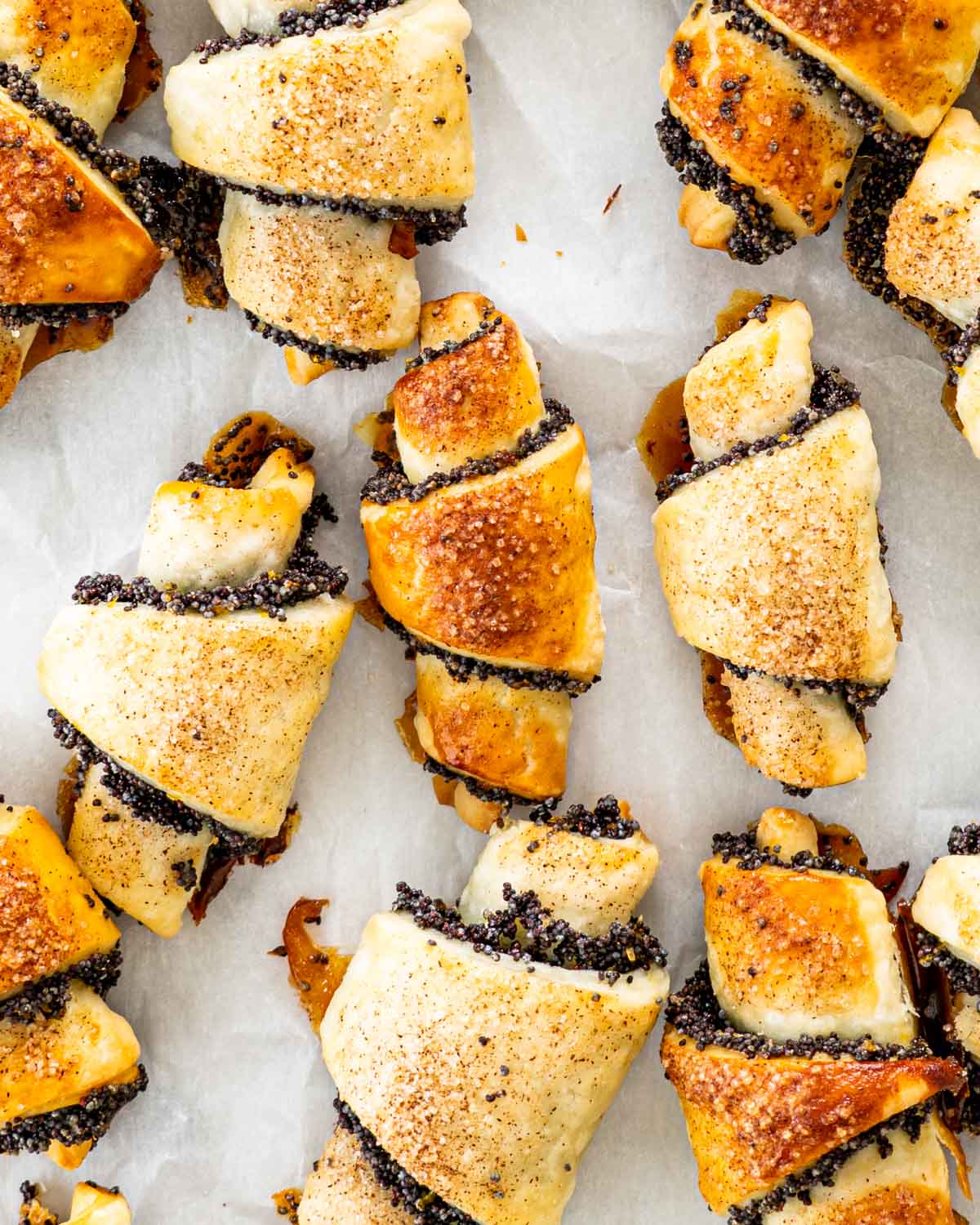 overhead shot of poppy seed rugelach on parchment paper.