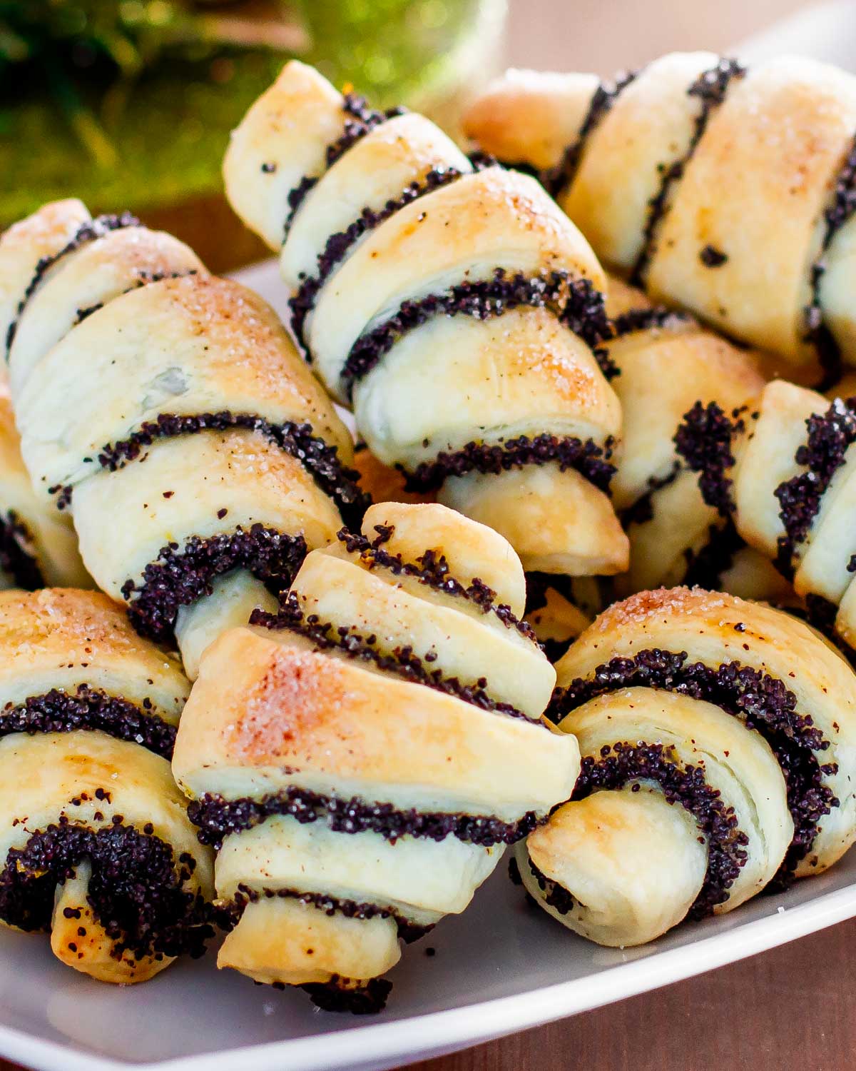 a bunch of poppy seed rugelach cookies on a plate.