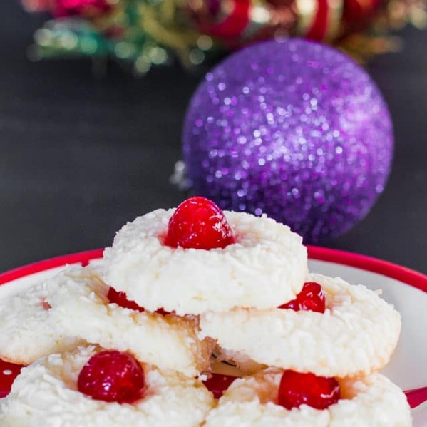 a plate full of yuletide coconut cherry cookies