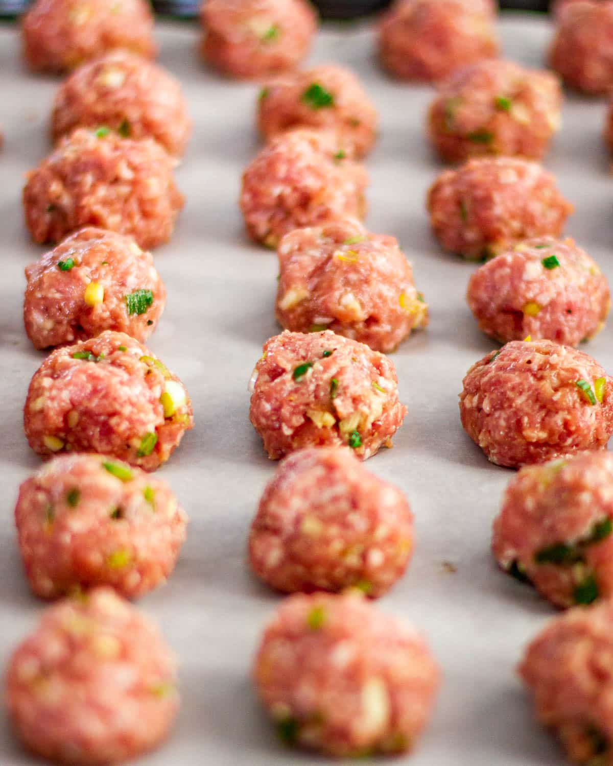 shaped meatballs on a baking sheet ready for baking