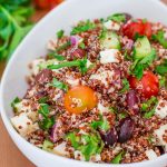 a bowl of greek chicken red quinoa salad