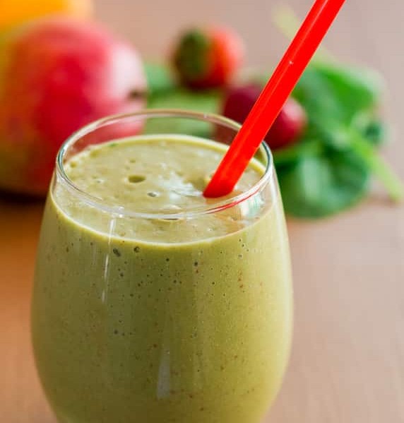 a glass of green smoothie with hemp hearts