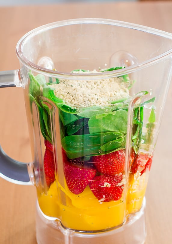 Mango, Strawberry and Spinach Smoothie ingredients in a blender
