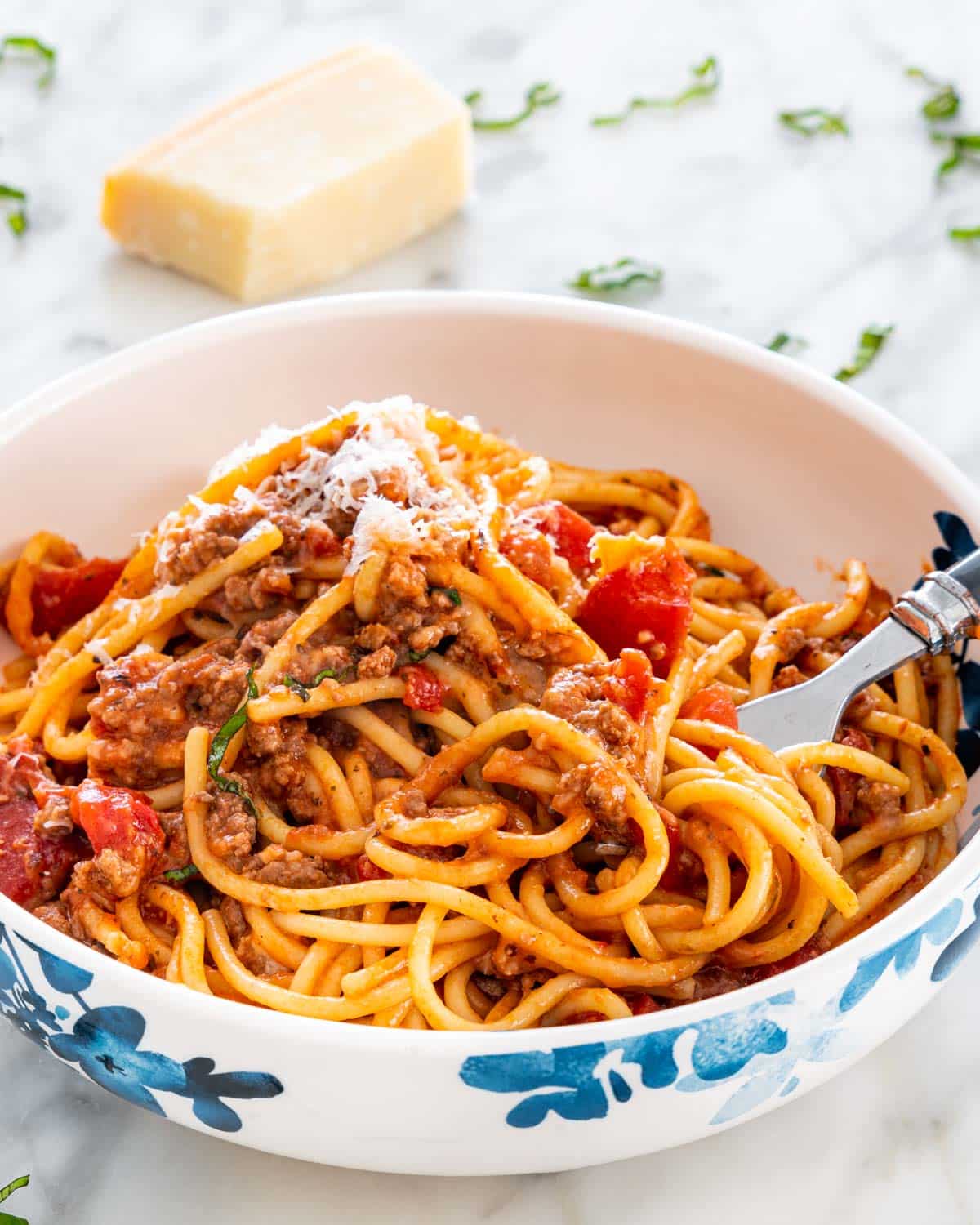 spaghetti casserole in a white and blue plate