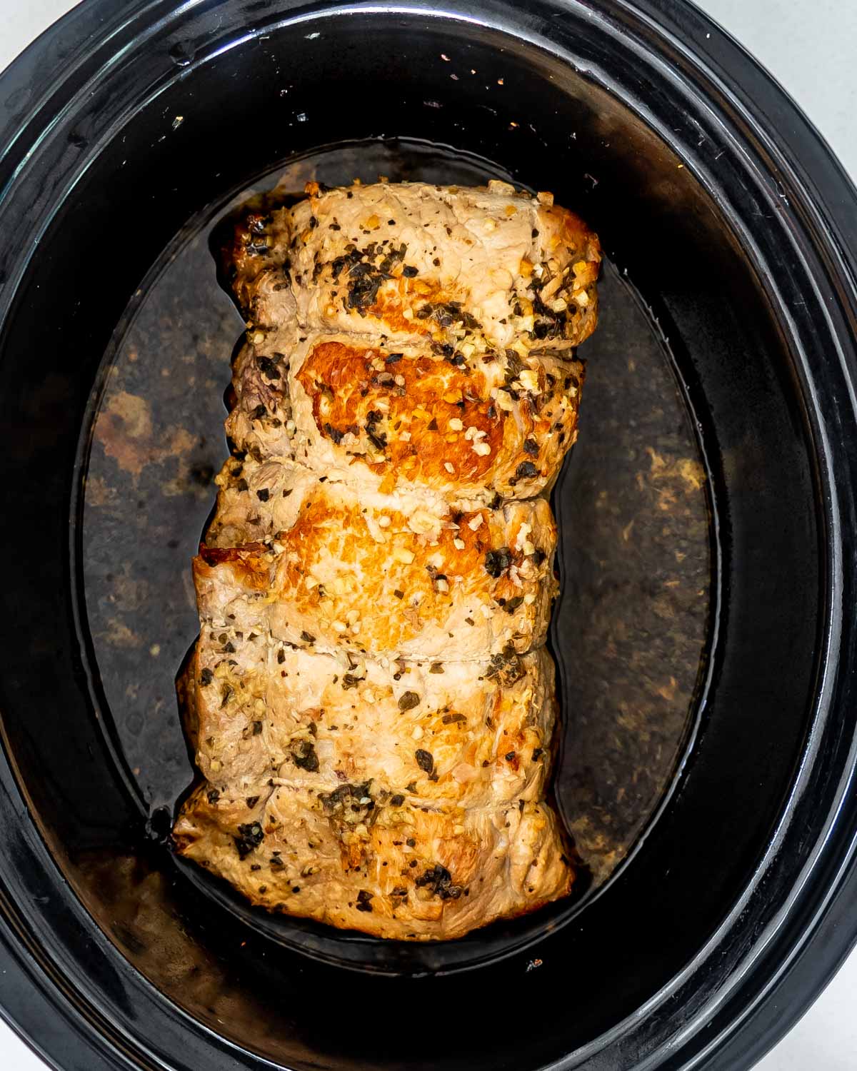 pork loin roasted in a cooking pot.