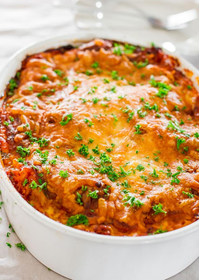 beef lasagna in a white casserole dish right out of the oven