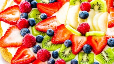overhead shot of a beautiful fruit pizza on a cookie crust with cream cheese frosting