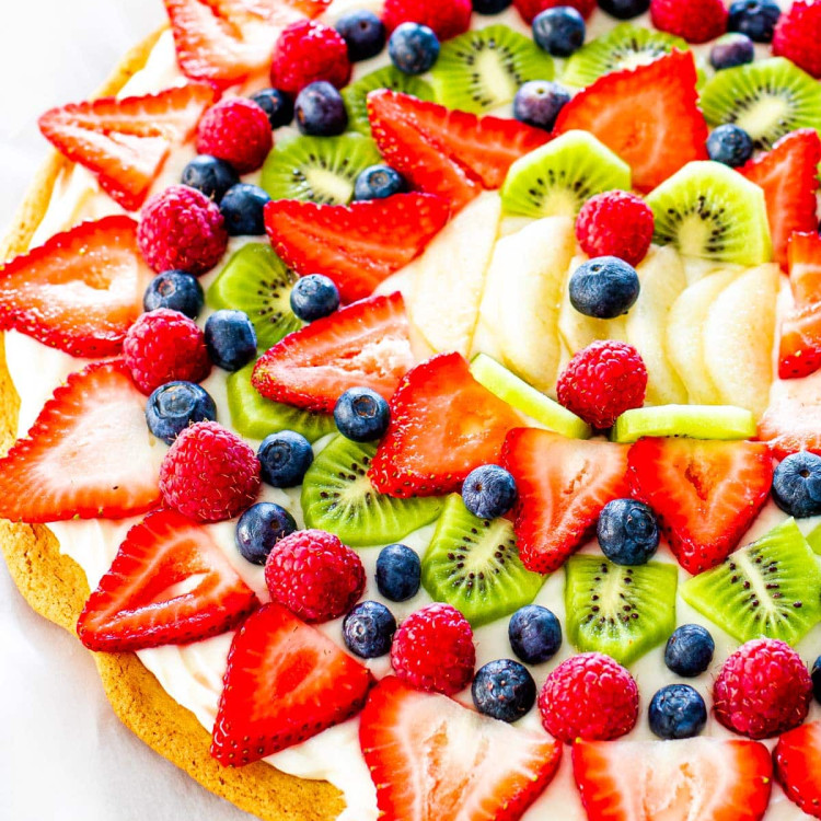 overhead shot of a beautiful fruit pizza on a cookie crust with cream cheese frosting