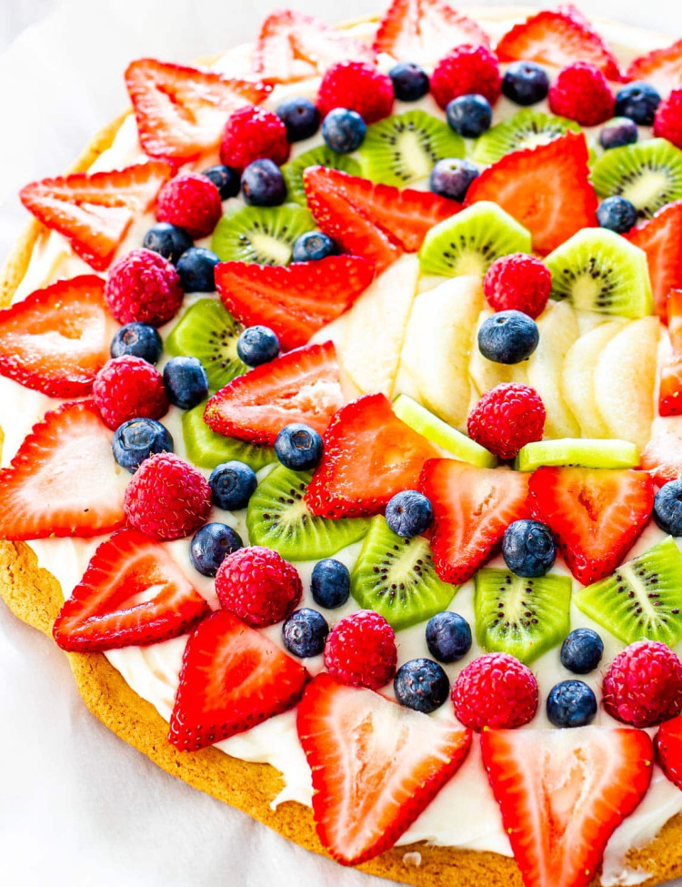 overhead shot of a beautiful fruit pizza on a cookie crust with cream cheese frosting