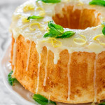 a lemon chiffon cake garnished with mint leaves and lemon zest