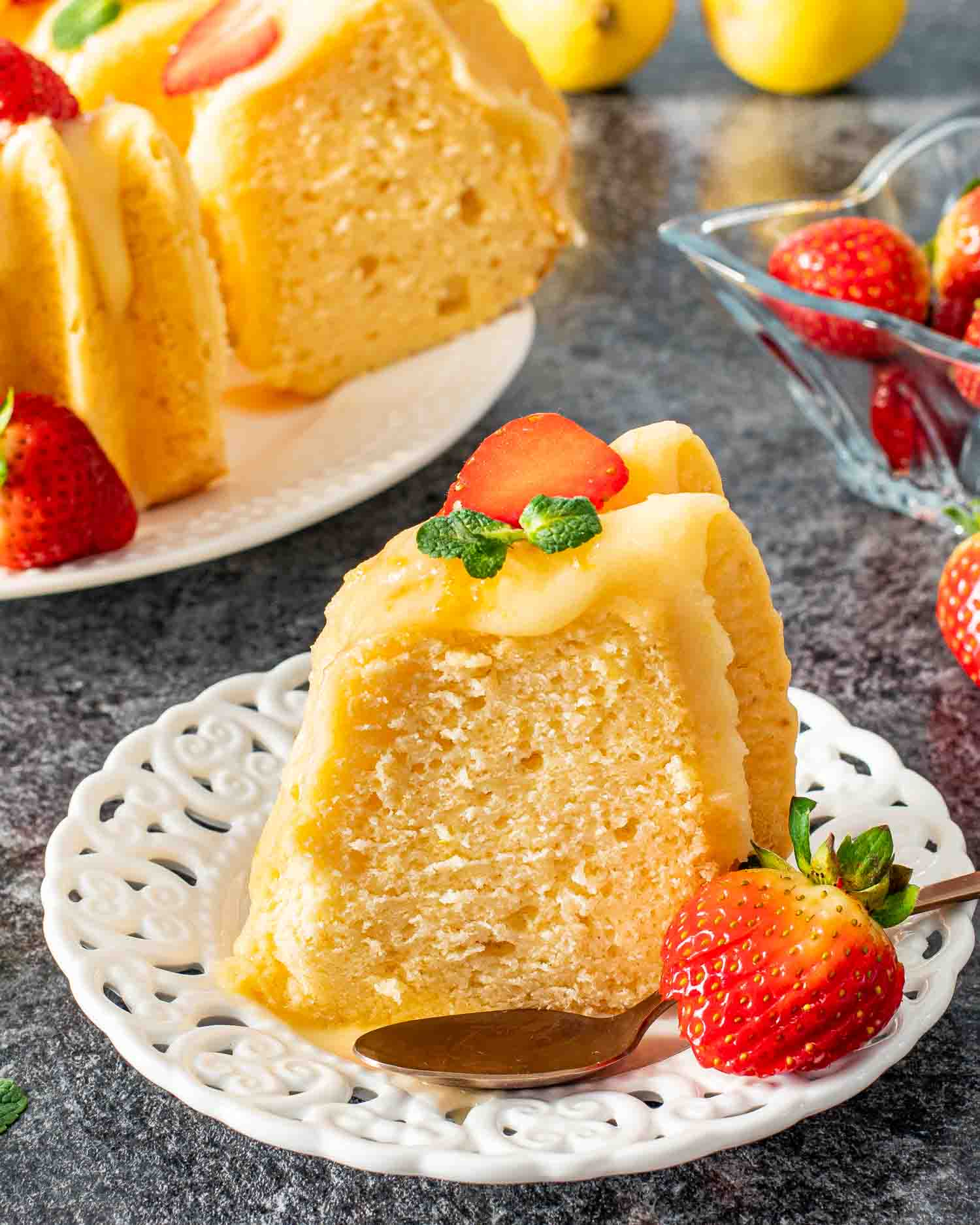 a slice of lemon chiffon cake on a white platter.