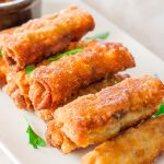 a plate full of pork and mushroom spring rolls