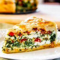 side view shot of a plate with a slice of spinach ricotta brunch bake on it