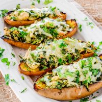 chipotle chicken stuffed sweet potato skins lined up on a plate