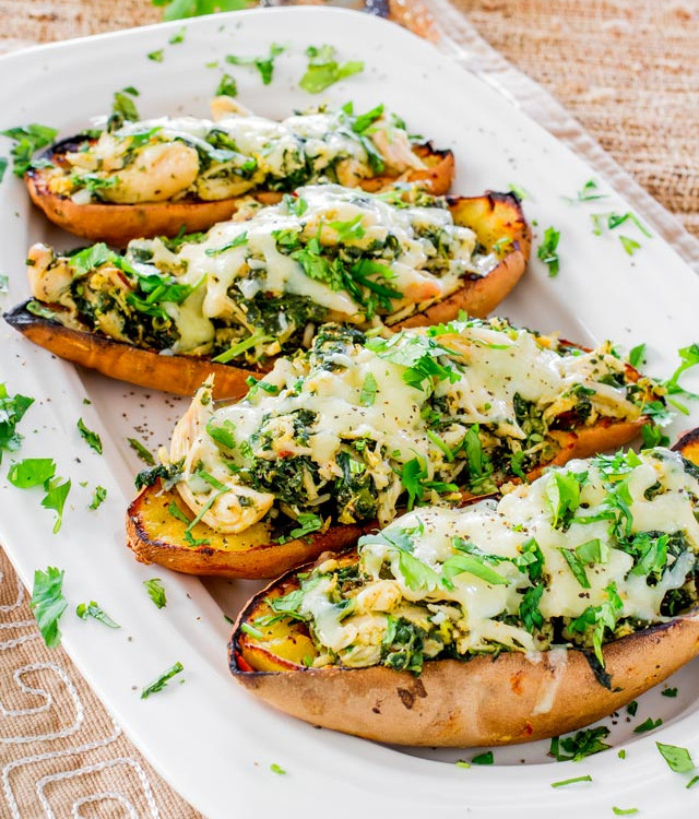chipotle chicken stuffed sweet potato skins lined up on a plate