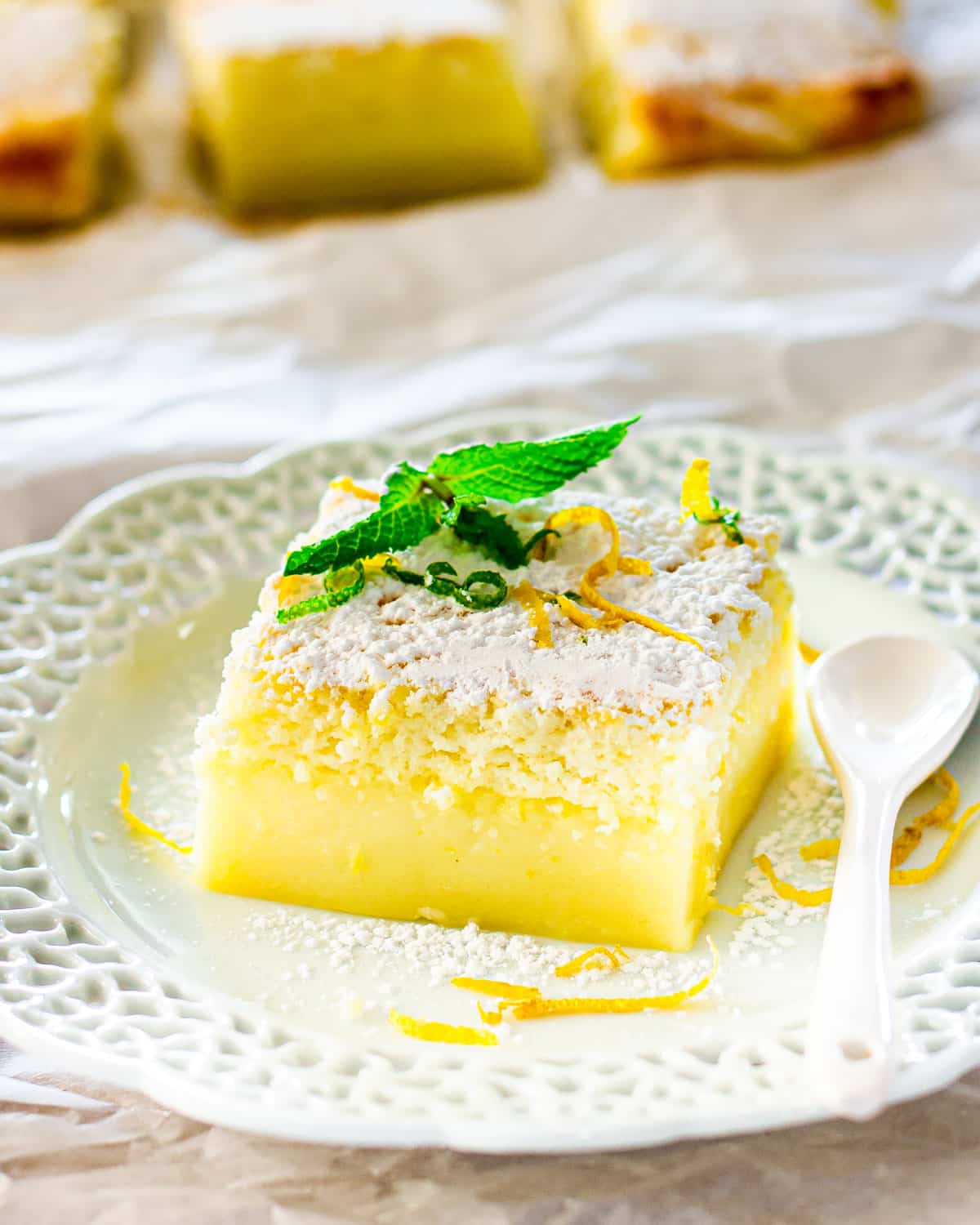 a slice of lemon magic cake on a white plate