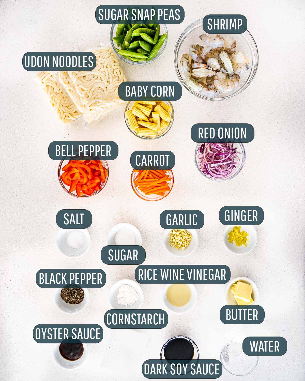 overhead shot of ingredients needed to make black pepper udon noodles with shrimp.