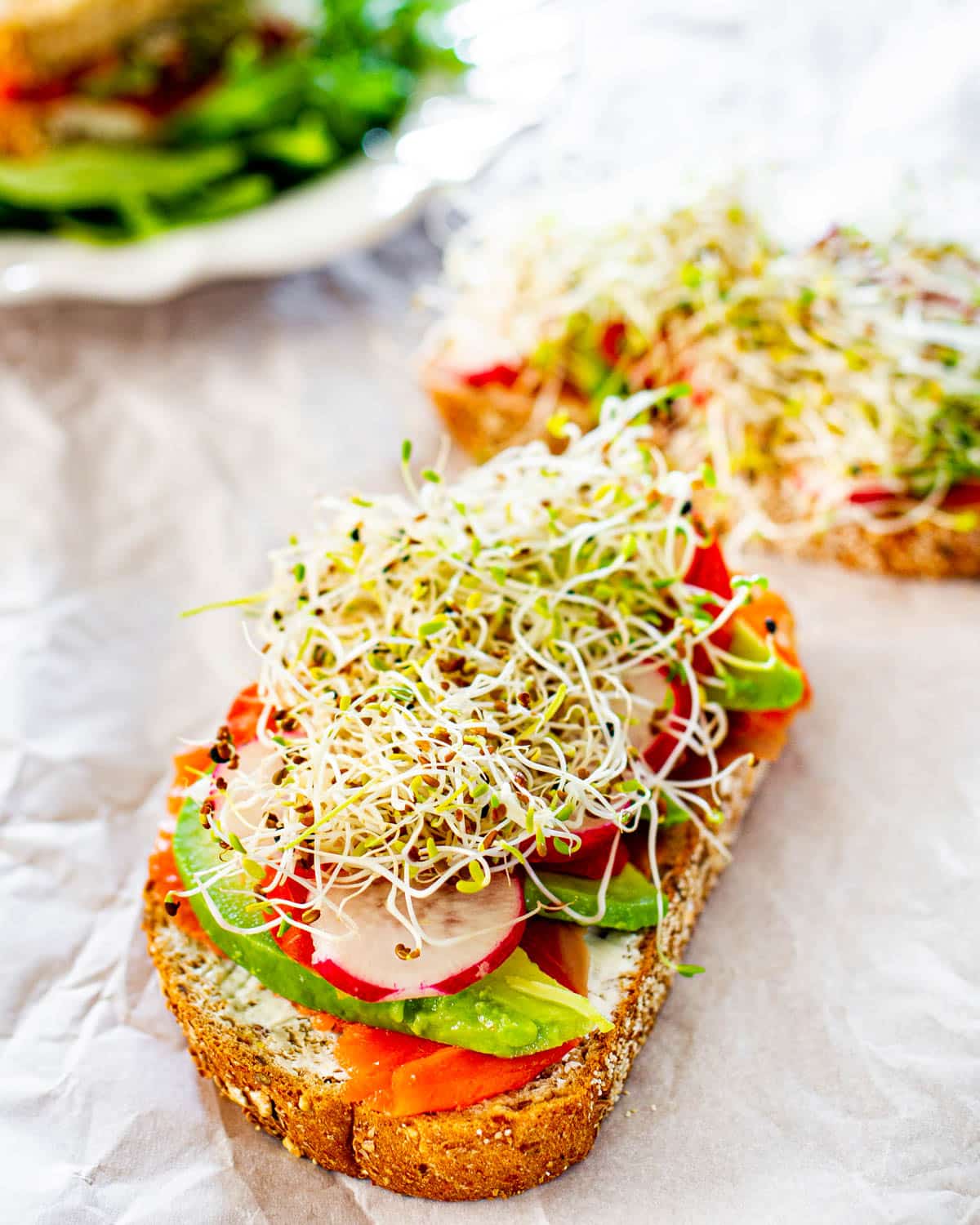 open faced sandwich with smoked salmon and veggies
