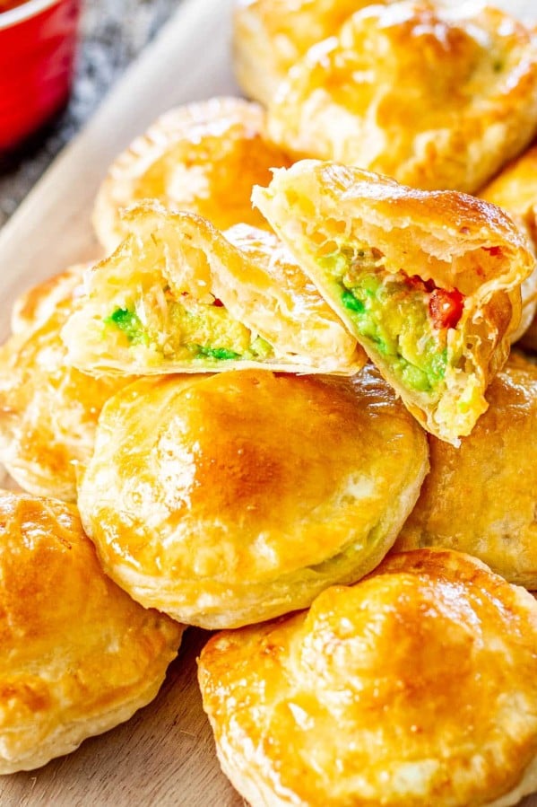avocado mozza puffs with one ripped in half with the center exposed