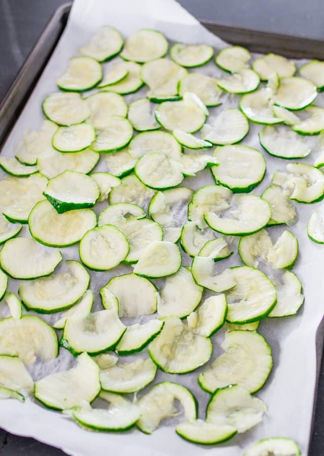 sliced zucchini on a baking sheet for Baked Zucchini Chips