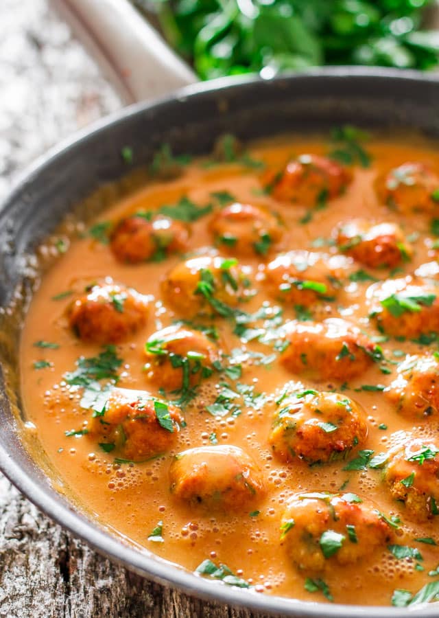 Skinny Thai Chicken Meatballs with peanut sauce in a skillet