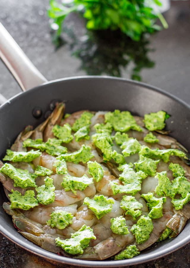 Garlic and Parsley Butter Shrimp in a skillet ready to go in the oven