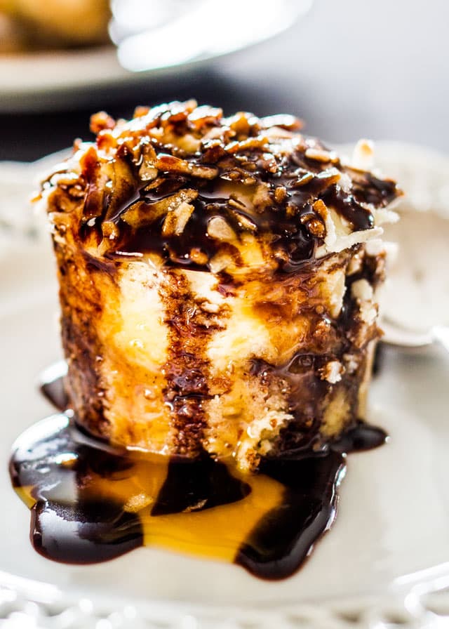 side view shot of a hawaiian cheesecake bite covered in chocolate sauce on a plate