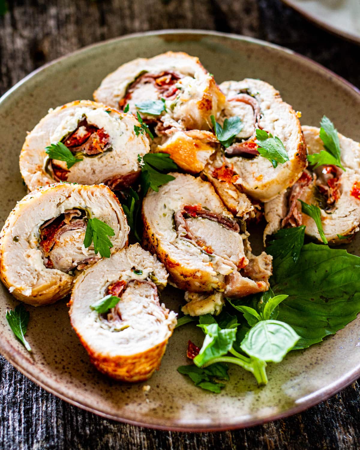 a plate of sliced up stuffed chicken breast