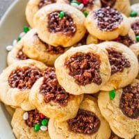 a pile of chocolate pecan pie cookies on a plate