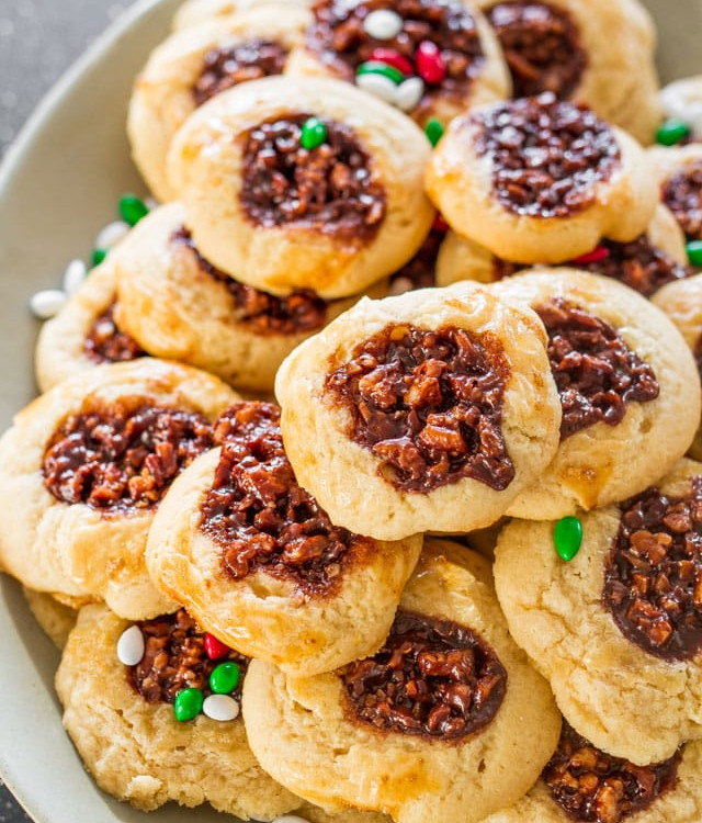 a pile of chocolate pecan pie cookies on a plate