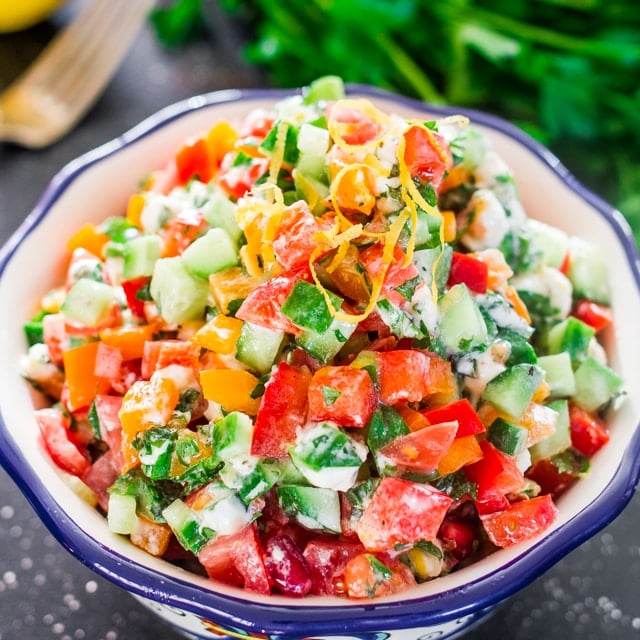 Israeli Salad with Goat Cheese - a delicious finely chopped veggie salad topped with goat cheese and herbs, making for a perfect light and healthy lunch.