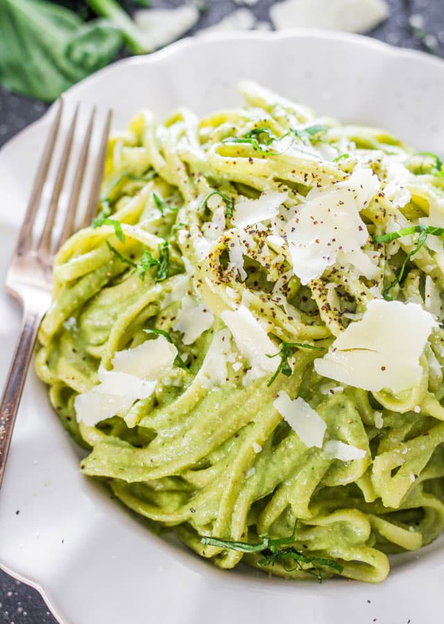 avocado and spinach pasta topped with parmesan cheese
