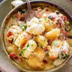 overhead shot of a fork taking a bite of ham and cheese gnocchi