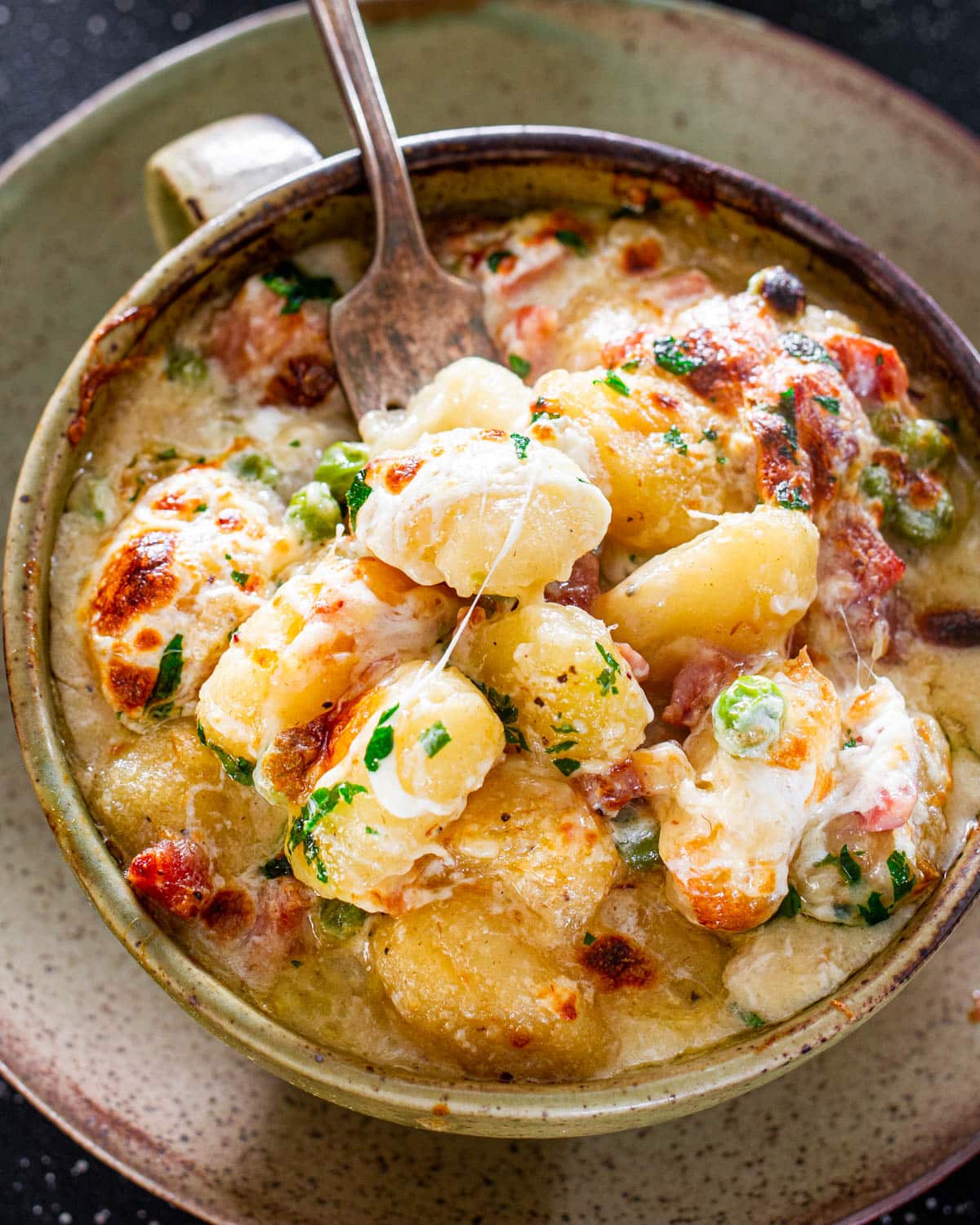 a bowl loaded with ham and cheese gnocchi
