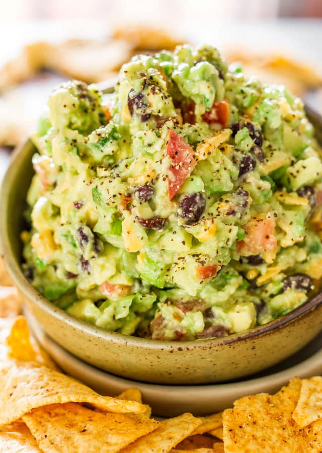 Close up shot of a bowl of Joe Montana's Touchdown Guacamole surrounded by tortilla chips