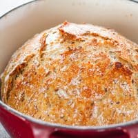 a freshly baked loaf of bread in a dutch oven