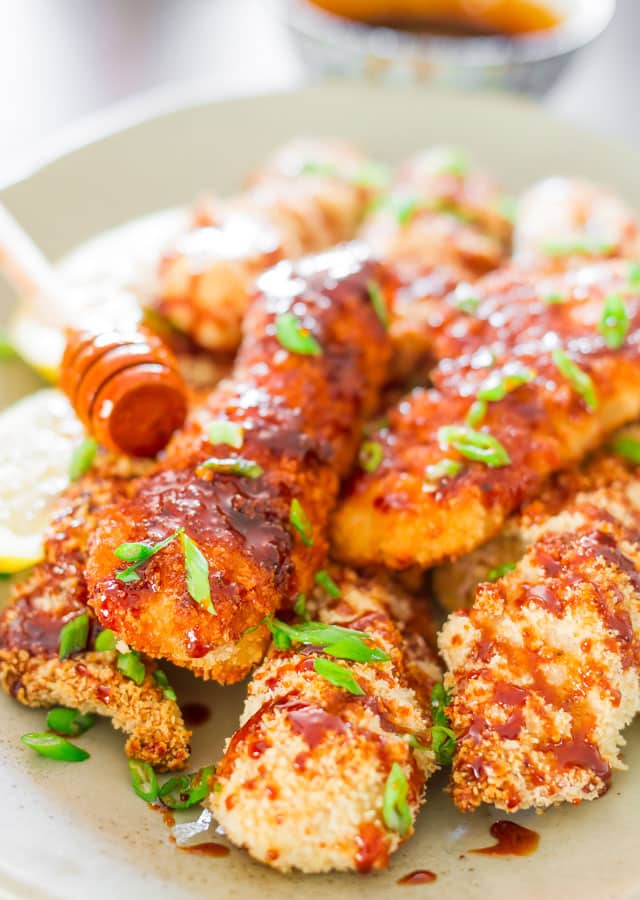 Asian Glazed Chicken Fingers - a healthy version of baked chicken fingers that are generously drizzled with an Asian inspired glaze.