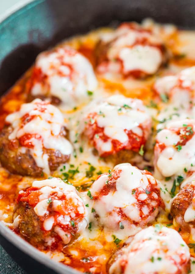 half a skillet loaded with meatball parmesan