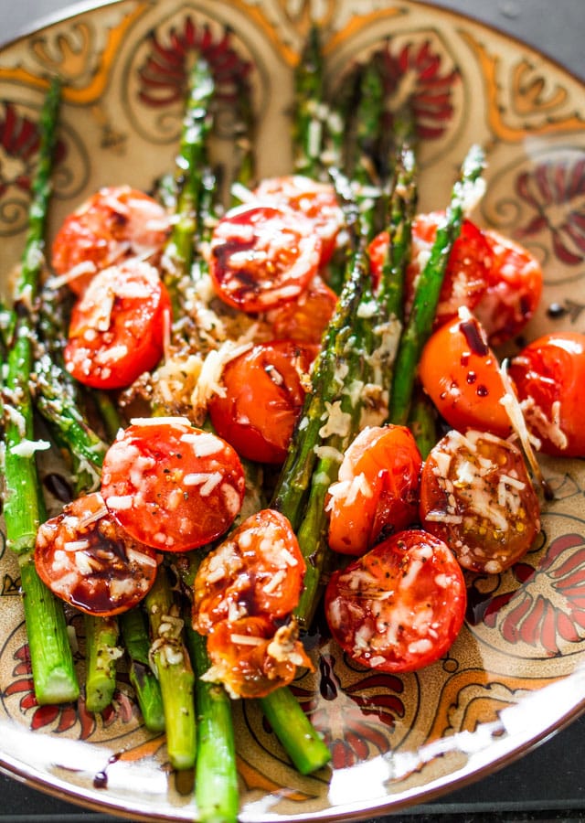 Balsamic Parmesan Roasted Asparagus and Tomatoes on a patterned plate