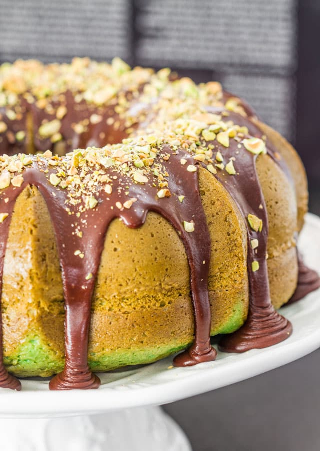 Pistachio Bundt Cake with Chocolate Ganache, topped with pistachios. 