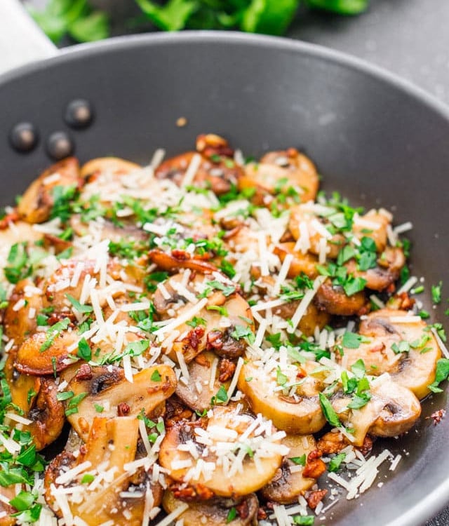 sauteed garlic and parmesan mushrooms in a skillet